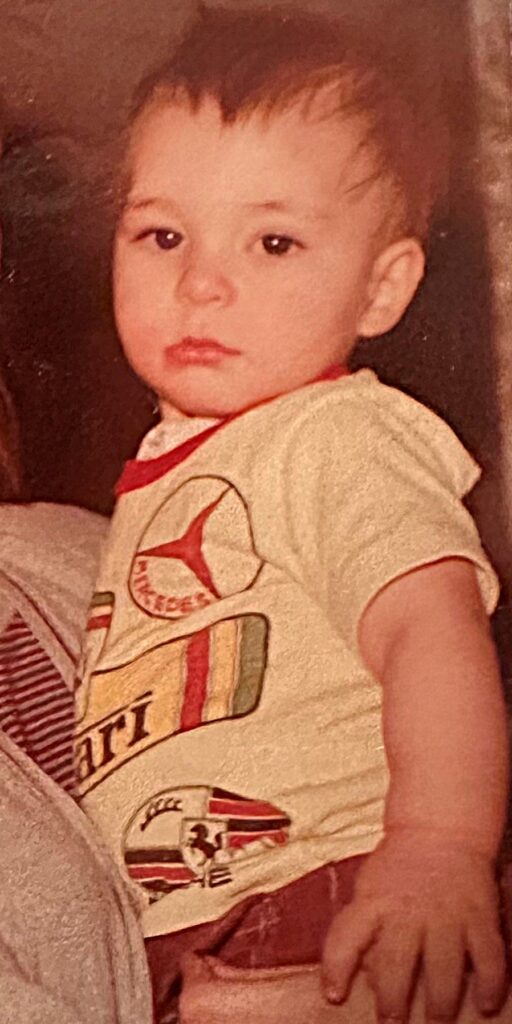 William at one to two years-old, looking into the camera with a serious expression